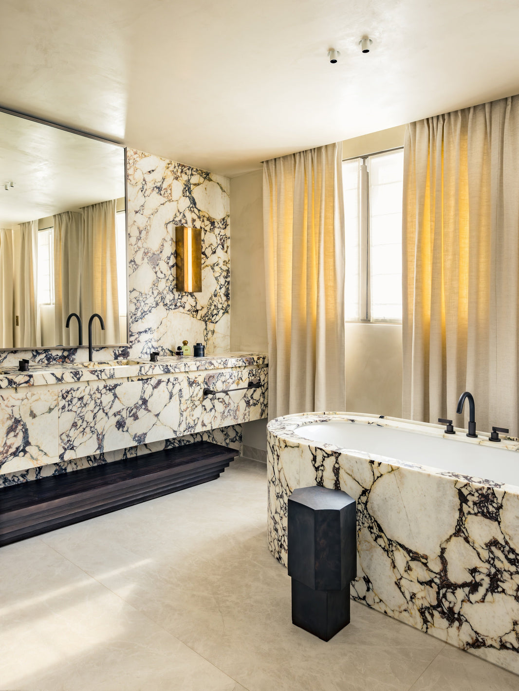 A Luxurious Marble Bathroom with Aged Iron Taps and Fittings