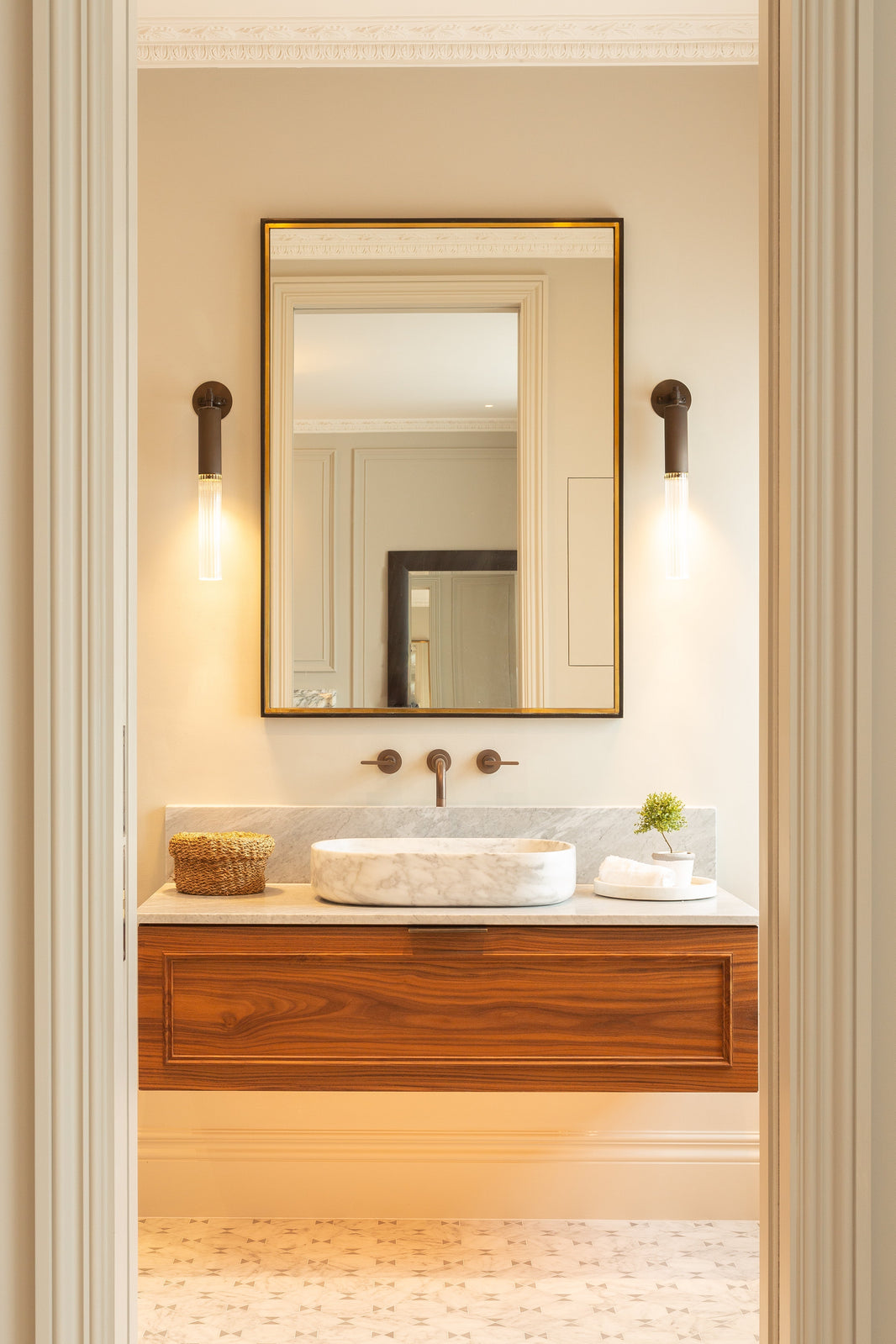 A Light and Neutral Bathroom with a wall mounted basin tap in polished brass