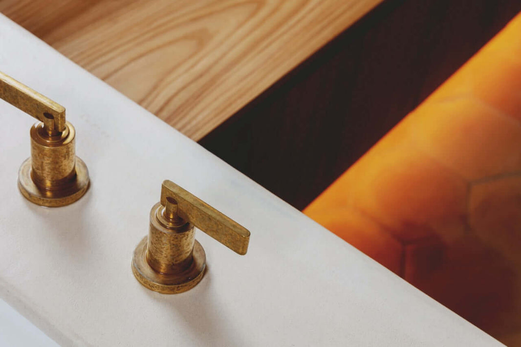 Two Ageing Polished Brass Faucet Controls