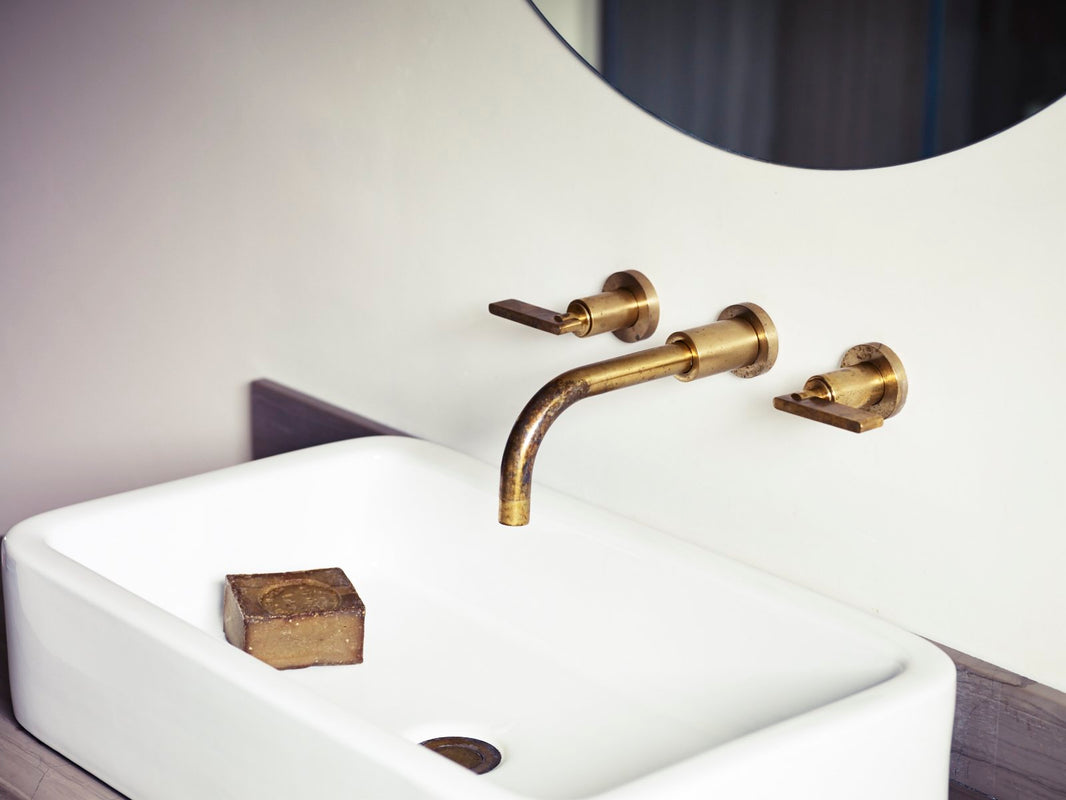 A Wall Mounted Basin Tap in an Unlacquered Brass Finish by Studio Ore