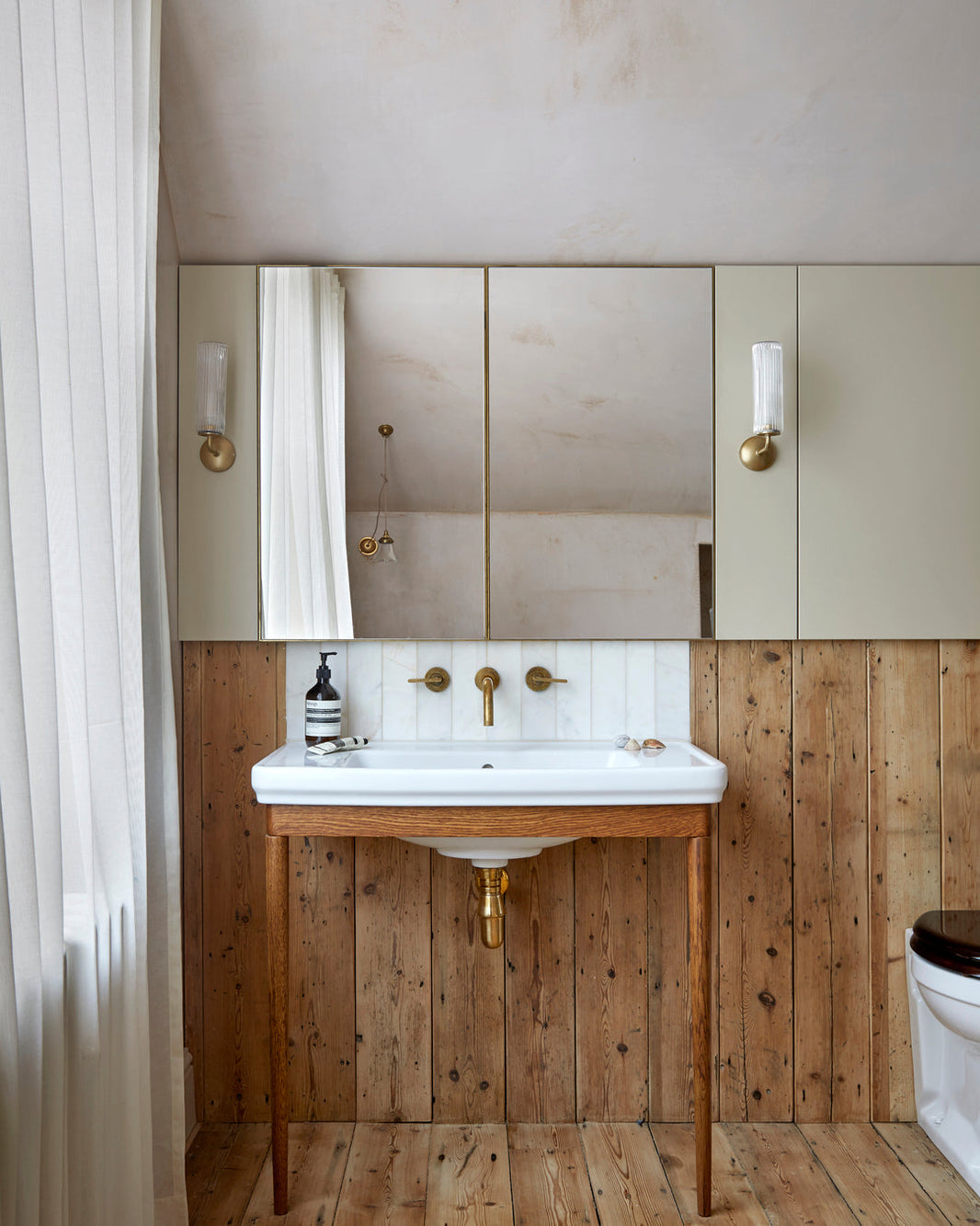 Studio Ore Unlacquered Brass taps in a rustic bathroom renovation.