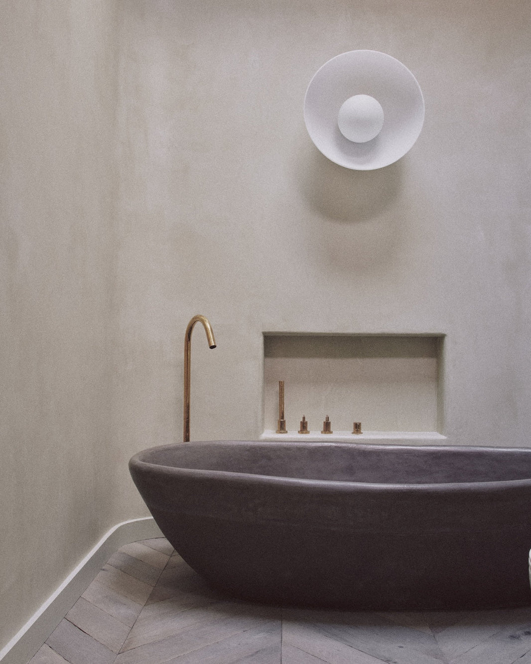 Studio Ore's fittings are paired with an organic bath by The Poured Project.