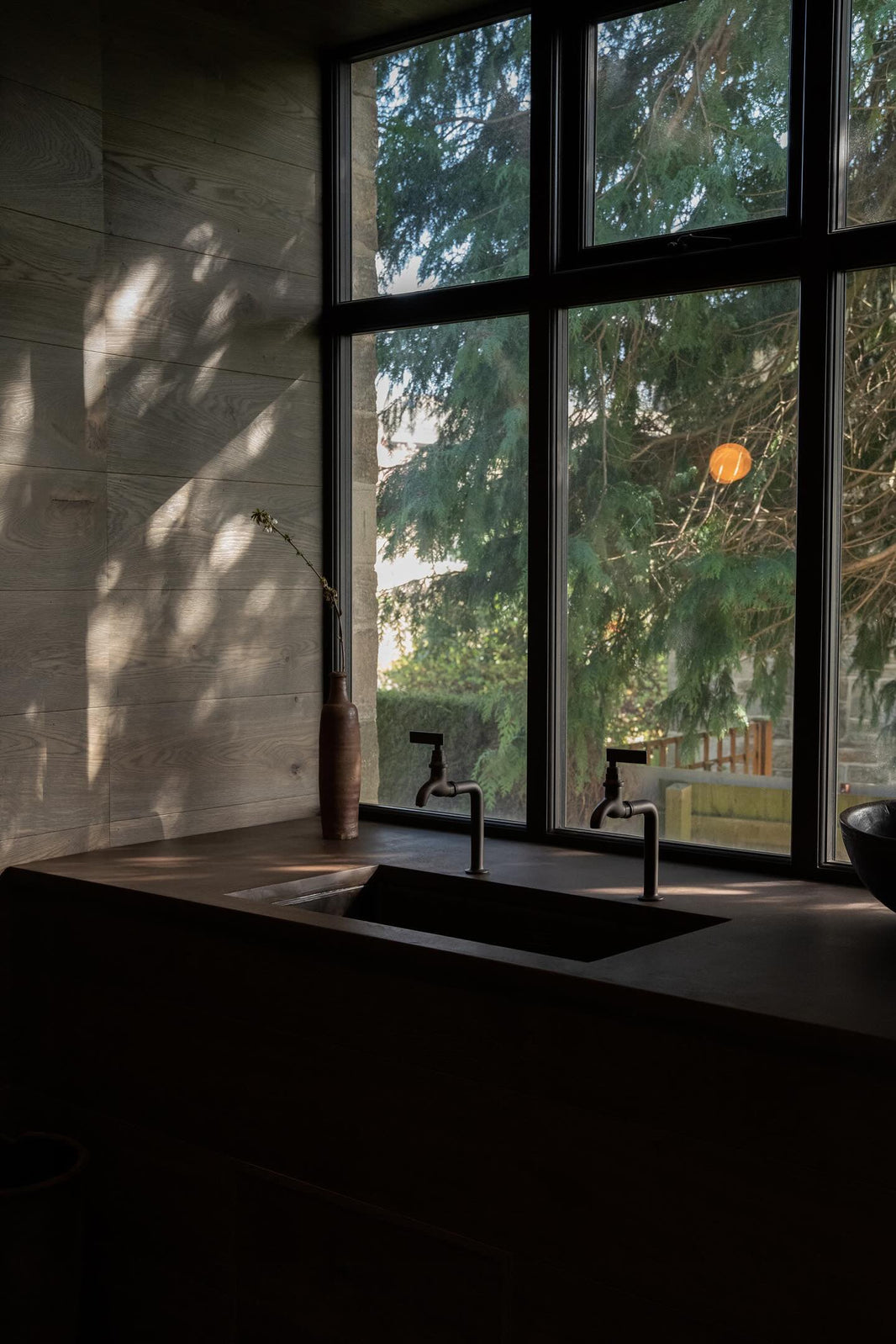 A Lacquered Aged Iron Bib Tap next to a standing sink