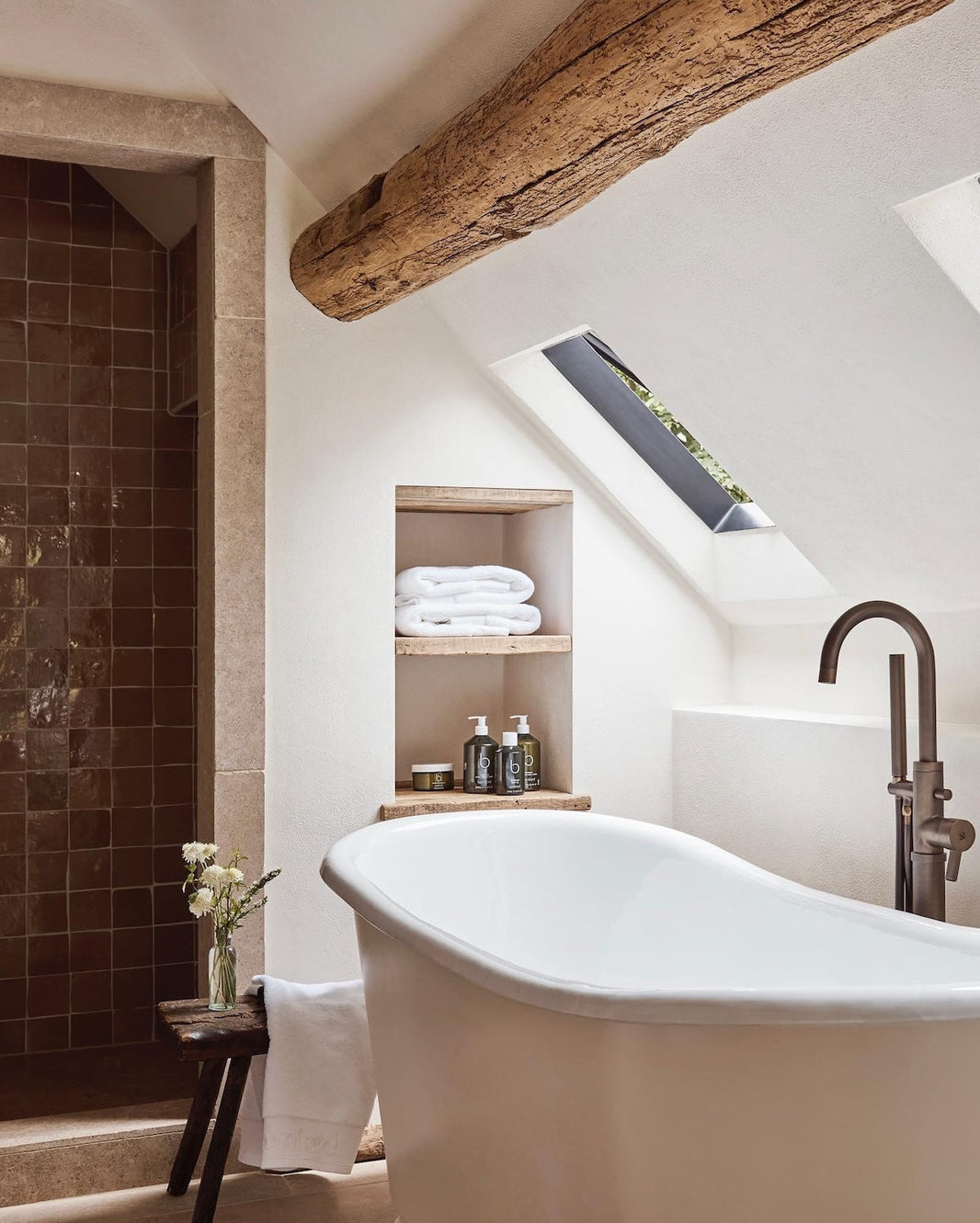 Studio Ore fittings can be found in the bathrooms at The Fox in Oddington. Here, our floor mounted bath mixer tap in lacquered bronze stands over a roll top bath in a period building.