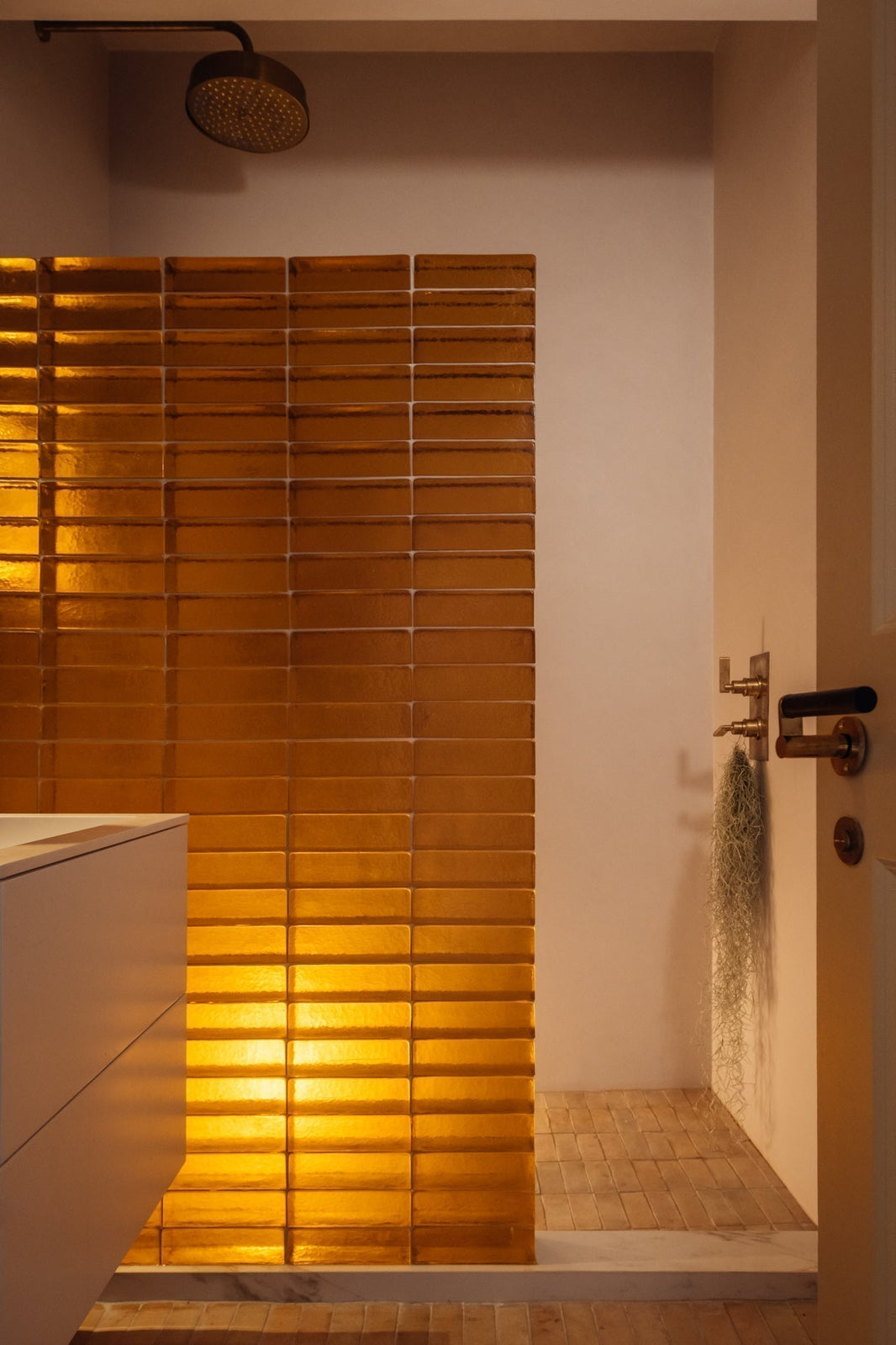 Studio Ore's Dual Shower Thermostat with two ways diverter, and Minimalist Shower Rose in the shower space of the bathroom. Both from Chapter One, and in our unlacquered polished brass finish. The fittings have already gained a characterful patina.