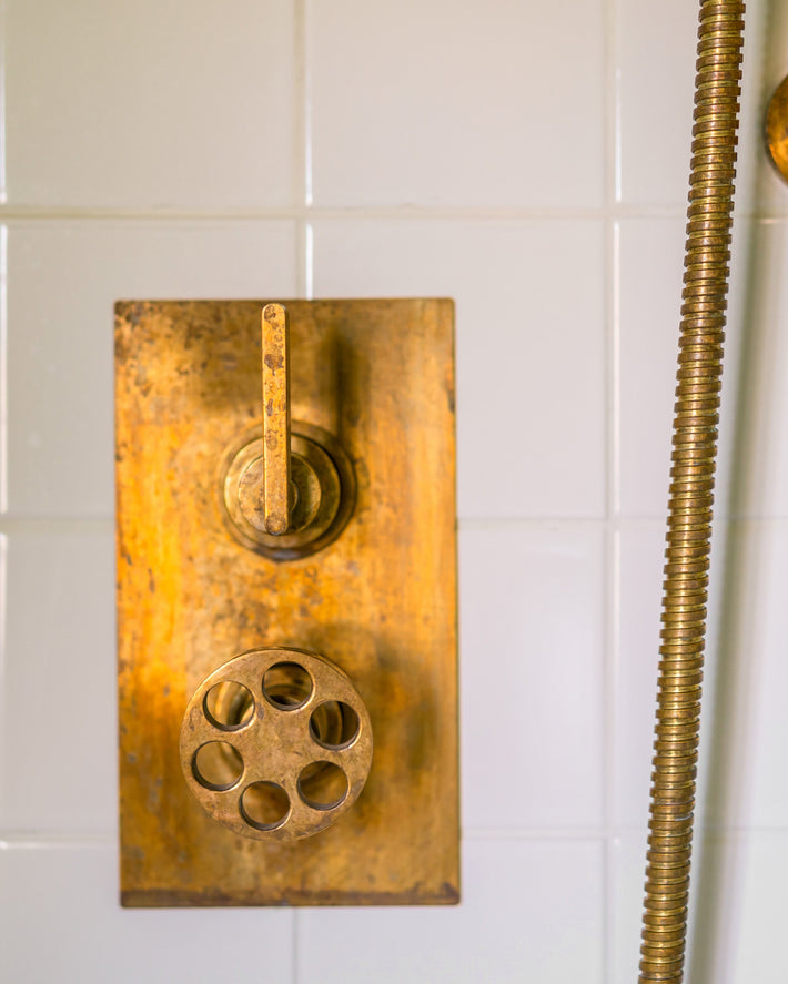 Patina on Studio ORE brass shower thermostat