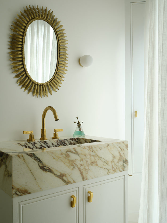 Small bathroom basin vanity with Studio Ore brass taps that have been deck mounted