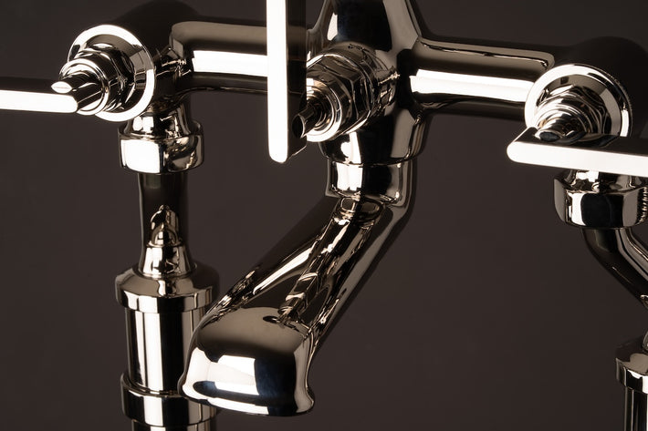 The details of Studio Ore's wall mounted bath mixer with hand shower in polished nickel. The fitting has a high shine, which will age gracefully over time. 