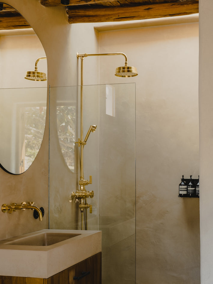 In this bathroom, designed by Ibiza Campo, our polished brass fittings sit against lime wash walls and under timber beams. There's ample light, it feels natural. 