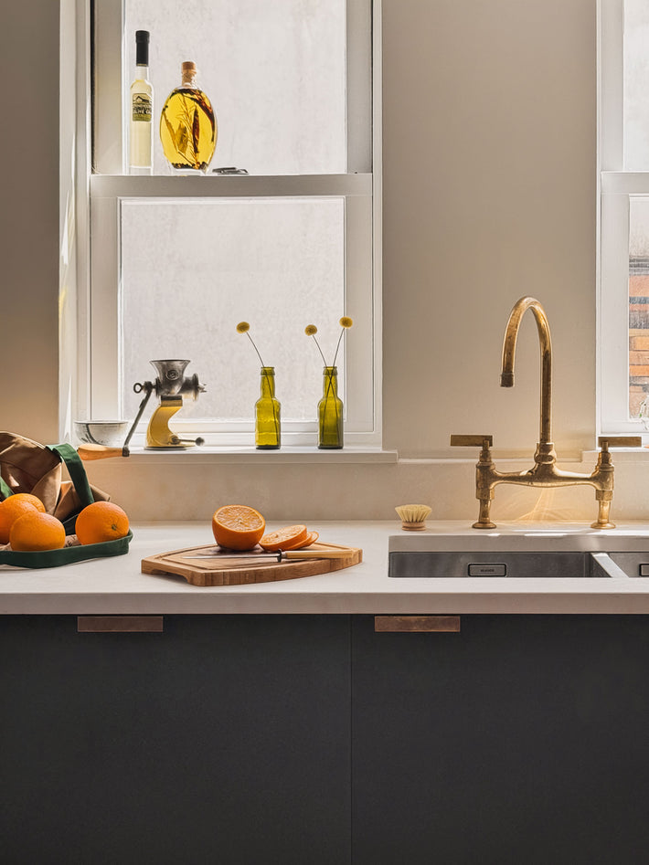 A closer look at Studio Ore's Kitchen Bridge Mixer tap in unlacquered polished brass. There's a light patination. It will continue to evolve with time and touch.