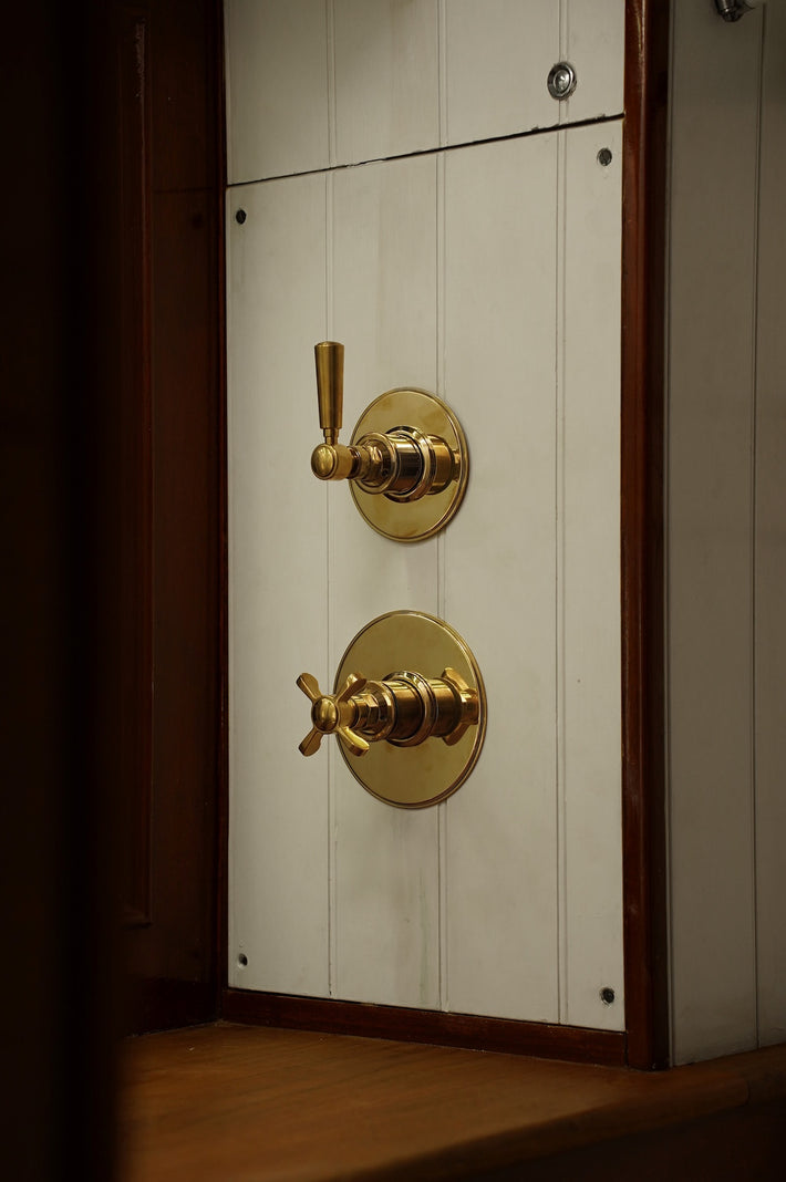 Studio Ore's wall mounted shower controls in unlacquered polished brass. From Chapter Four, the look is traditional. 