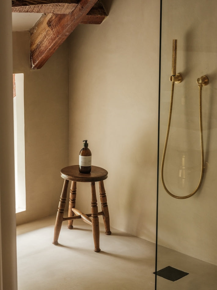 Ensuite bathroom at Osip, featuring Studio Ore's Wall Mounted Cylindrical Hand Shower, Hose and Mount. 