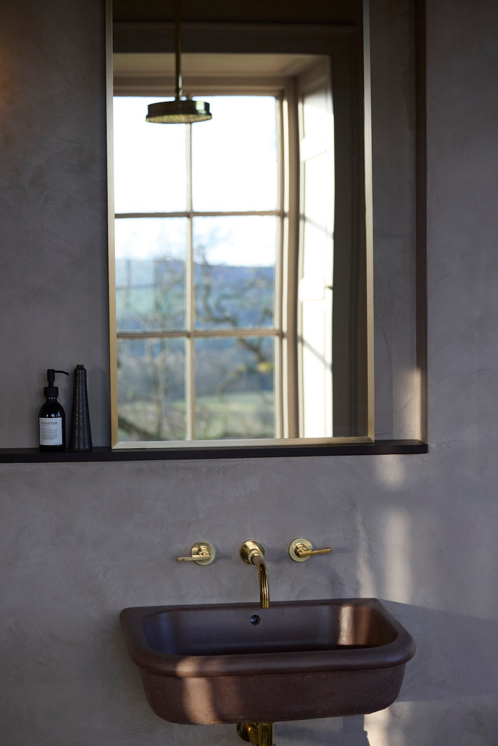 Studio Ore's solid brass fittings in unlacquered polished brass are found at Denton Hall. 