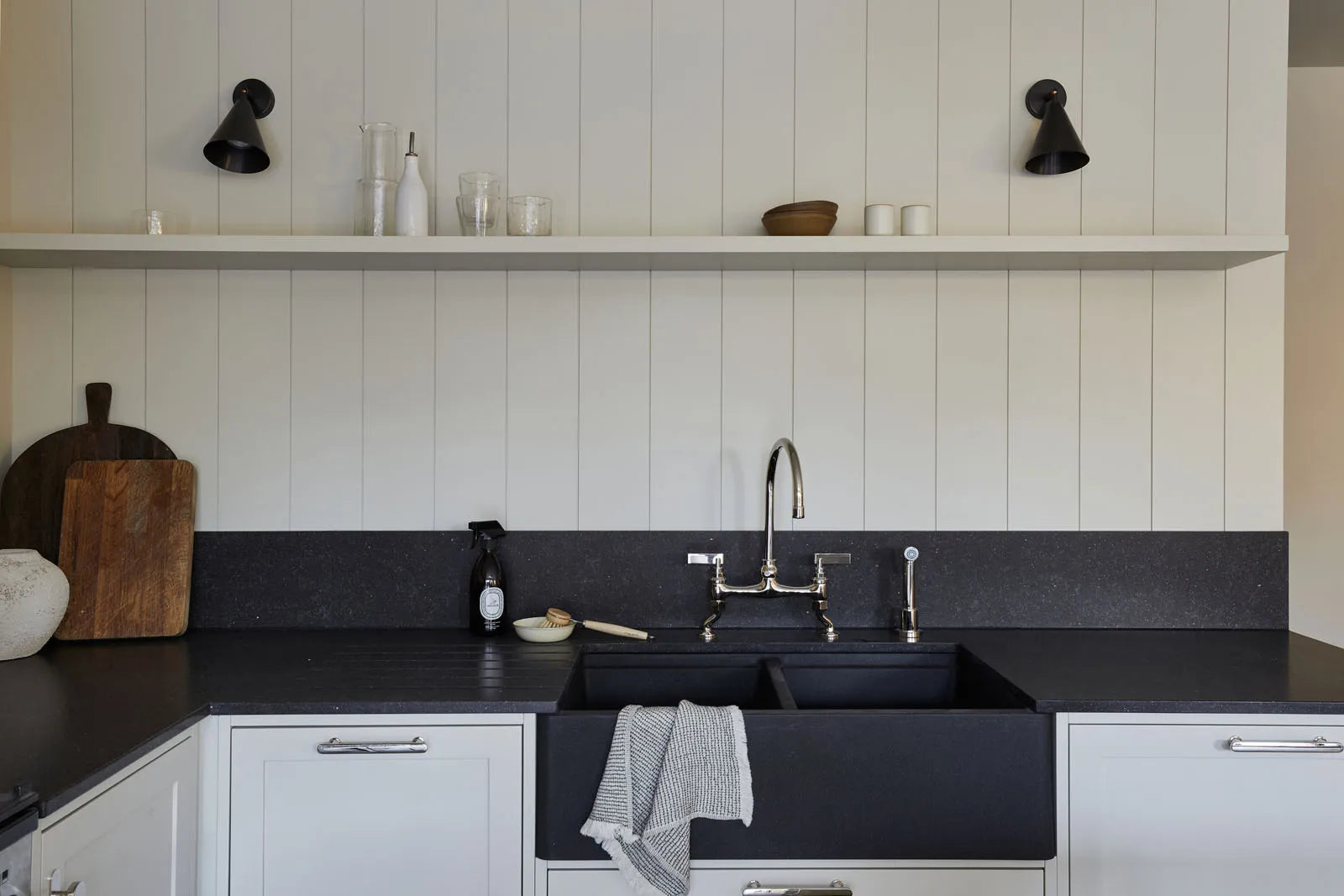 Studio Ore's kitchen bridge mixer tap and hand rinse from Chapter Two in polished nickel stands in this monochromatic kitchen designed by Tristan Domecq.
