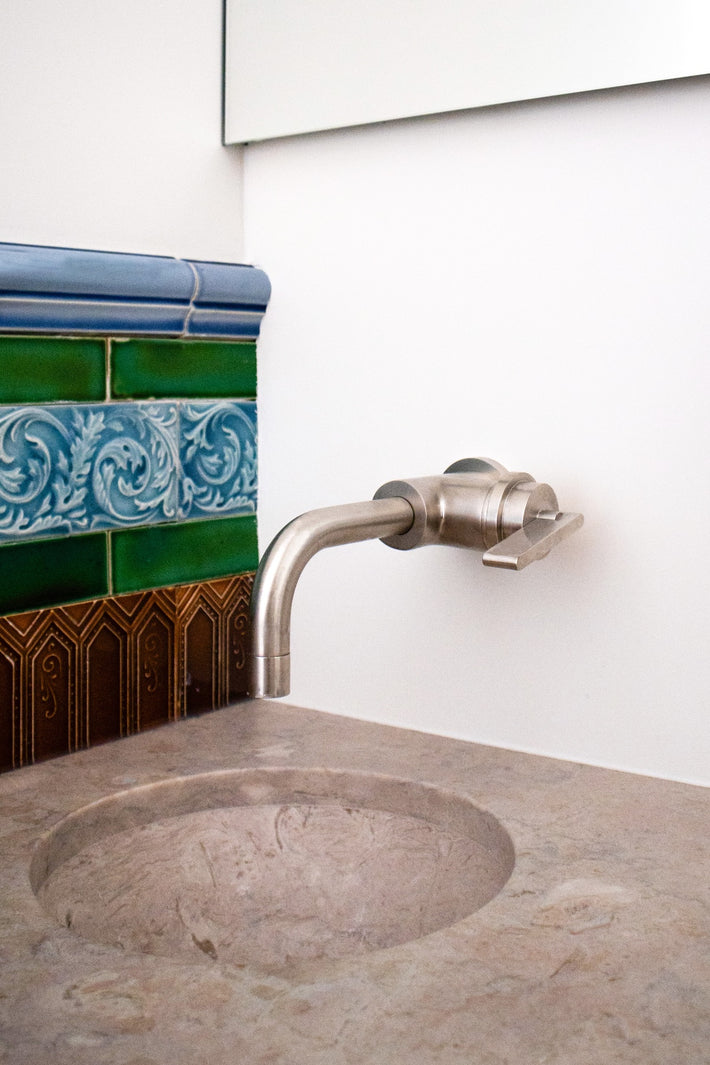 Studio Ore fittings can be found in Lioz, a hotel in Lisbon designed by REABILITA. The design is minimal. Here, the wall mounted basin mixer tap in brushed nickel is in the bathroom. 
