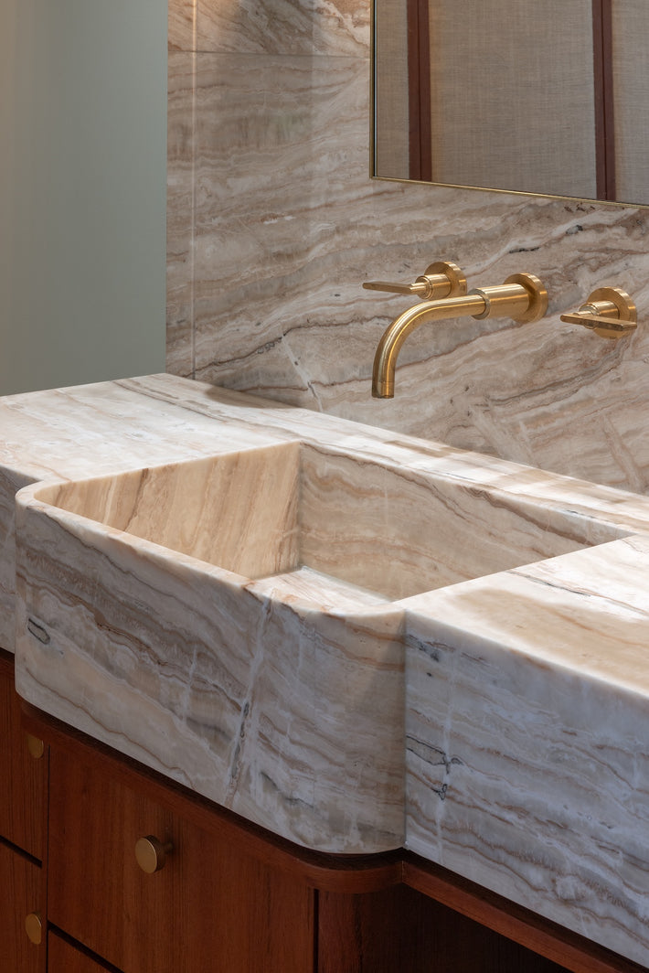 Close up detail of the unlacquered brushed brass finish on Studio Ore's industrial-style basin tap. 