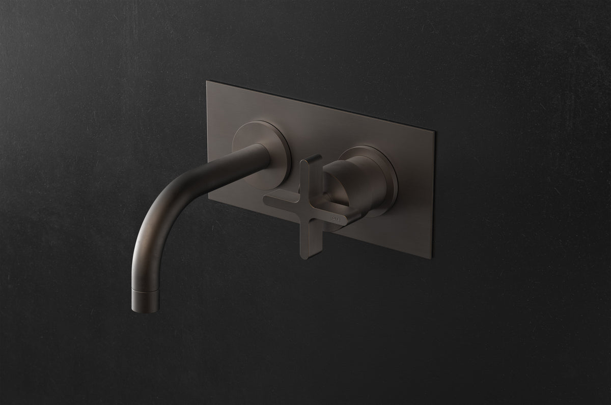 Studio Ore Chapter Three Two Hole Wall Mounted Basin Mixer with Curved Spout and Backplate with Cross handle in bronze