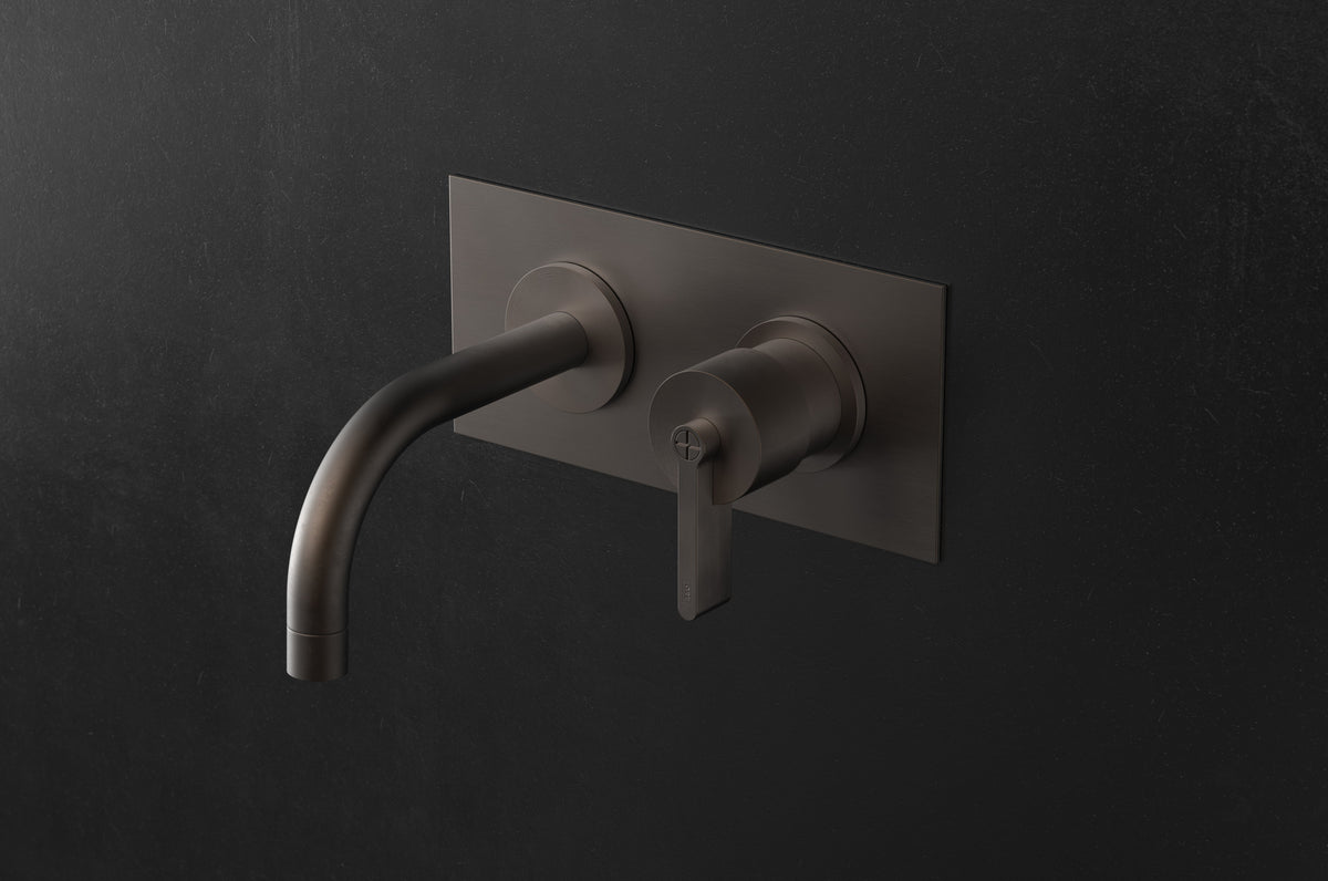 Studio Ore Chapter Three Two Hole Wall Mounted Basin Mixer with Curved Spout and Backplate with Teardrop Lever handle in bronze
