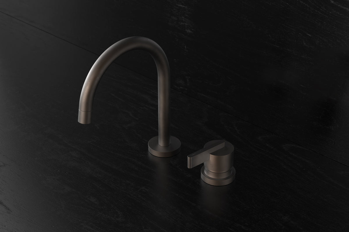Studio Ore Chapter Three Two Hole Deck Mounted Basin Mixer with Curved Spout with Lever handle in bronze