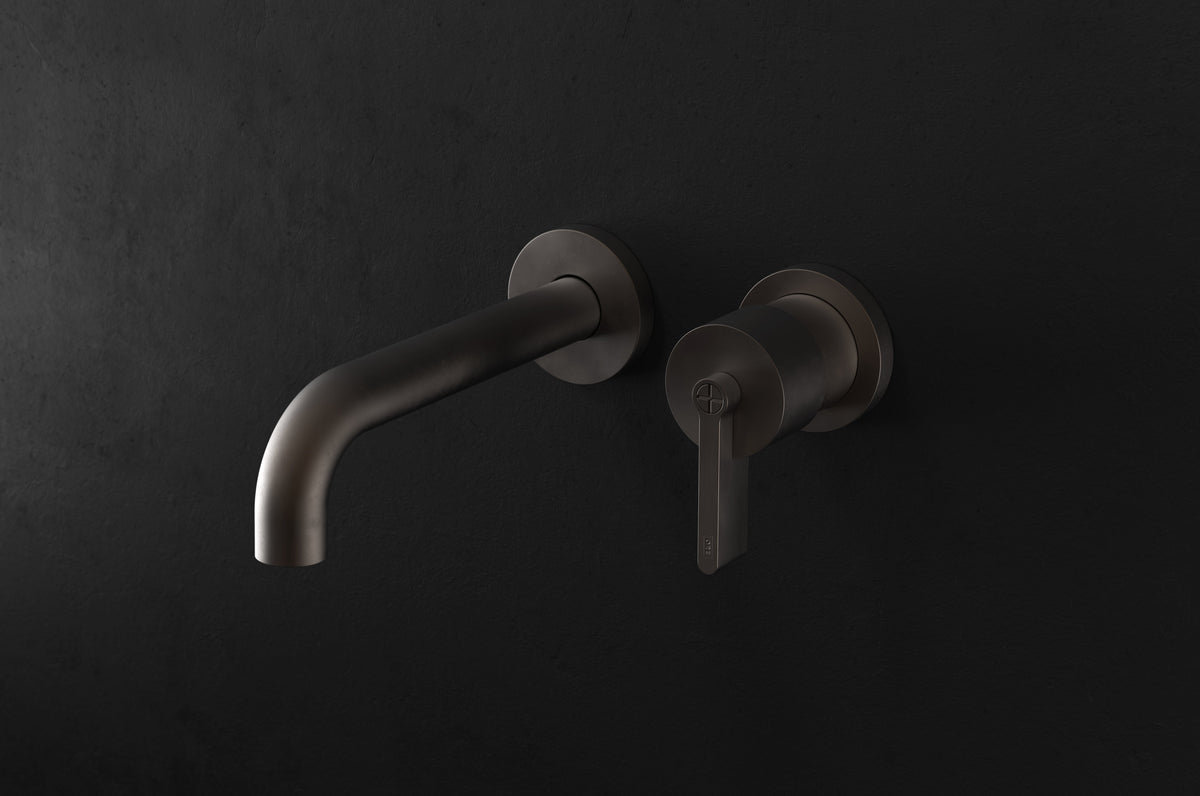 Studio Ore Chapter Three Two Hole Wall Mounted Basin Mixer with Angled Spout with Teardrop Lever handle in bronze, long spout