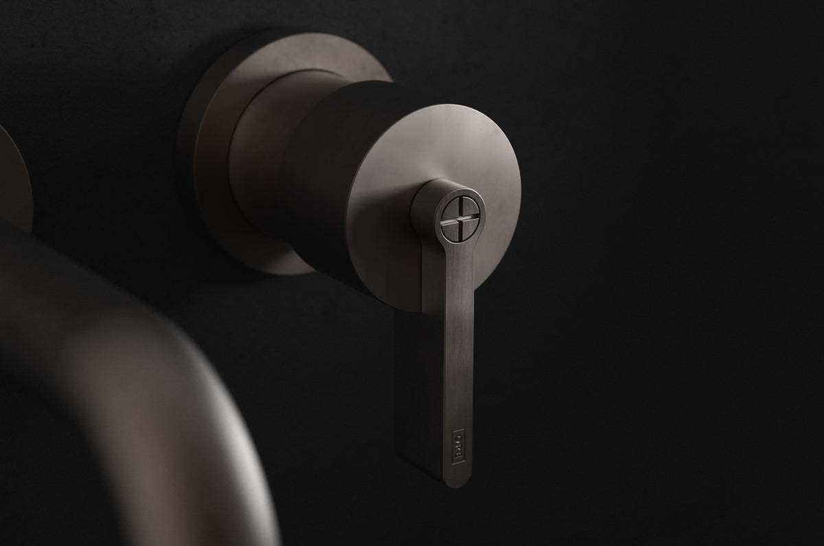 Studio Ore Chapter Three Two Hole Wall Mounted Basin Mixer with Angled Spout with Teardrop Lever handle in bronze, short spout, detail view