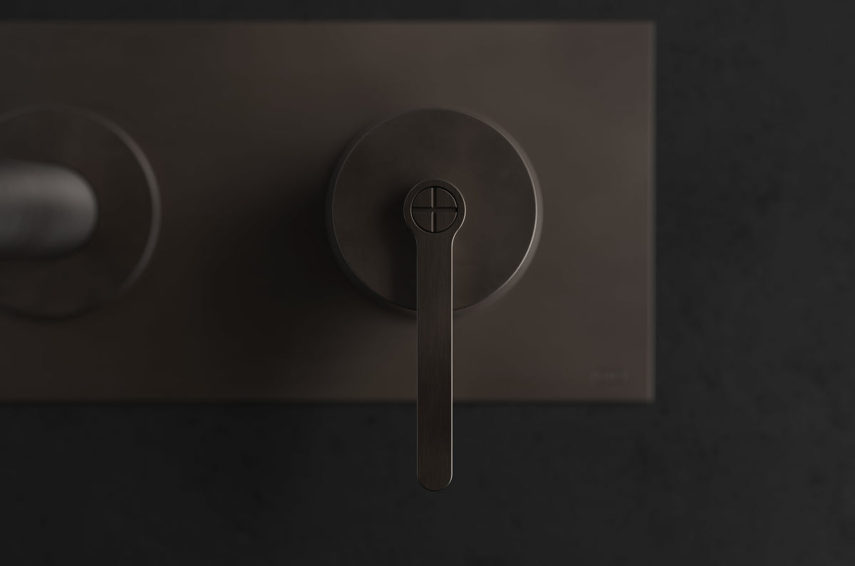 Studio Ore Chapter Three Two Hole Wall Mounted Basin Mixer with Angled Spout and Backplate with Cross handle in bronze, short spout, detail view
