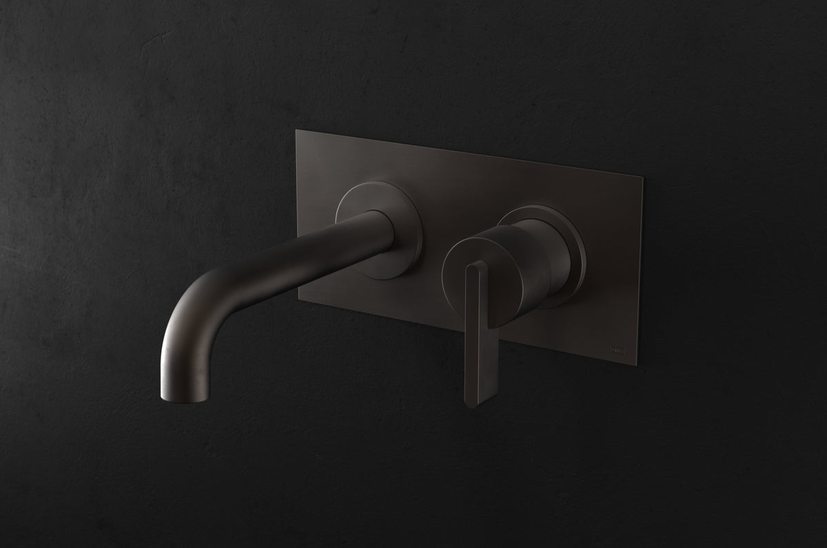 Studio Ore Chapter Three Two Hole Wall Mounted Basin Mixer with Angled Spout and Backplate with Lever handle in bronze, long spout