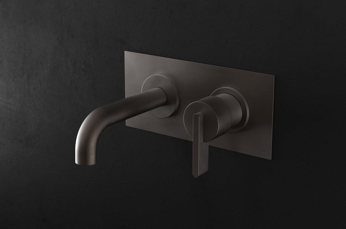 Studio Ore Chapter Three Two Hole Wall Mounted Basin Mixer with Angled Spout and Backplate with Lever handle in bronze, short spout