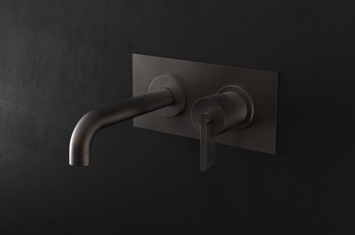 Studio Ore Chapter Three Two Hole Wall Mounted Basin Mixer with Angled Spout and Backplate with Teardrop Lever handle in bronze, long spout