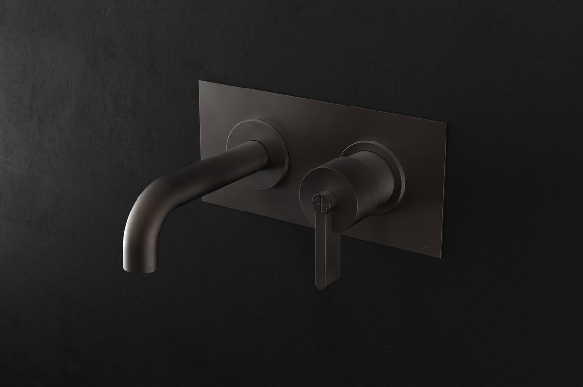 Studio Ore Chapter Three Two Hole Wall Mounted Basin Mixer with Angled Spout and Backplate with Teardrop Lever handle in bronze, short spout