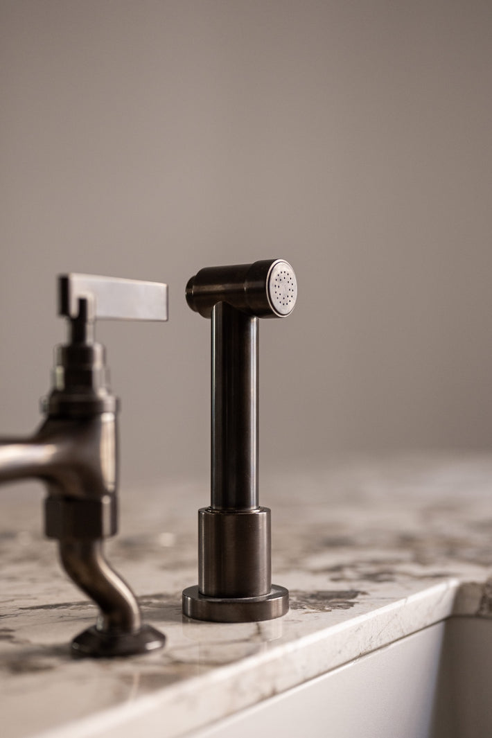 Studio Ore's kitchen hand rinse in lacquered bronze. 